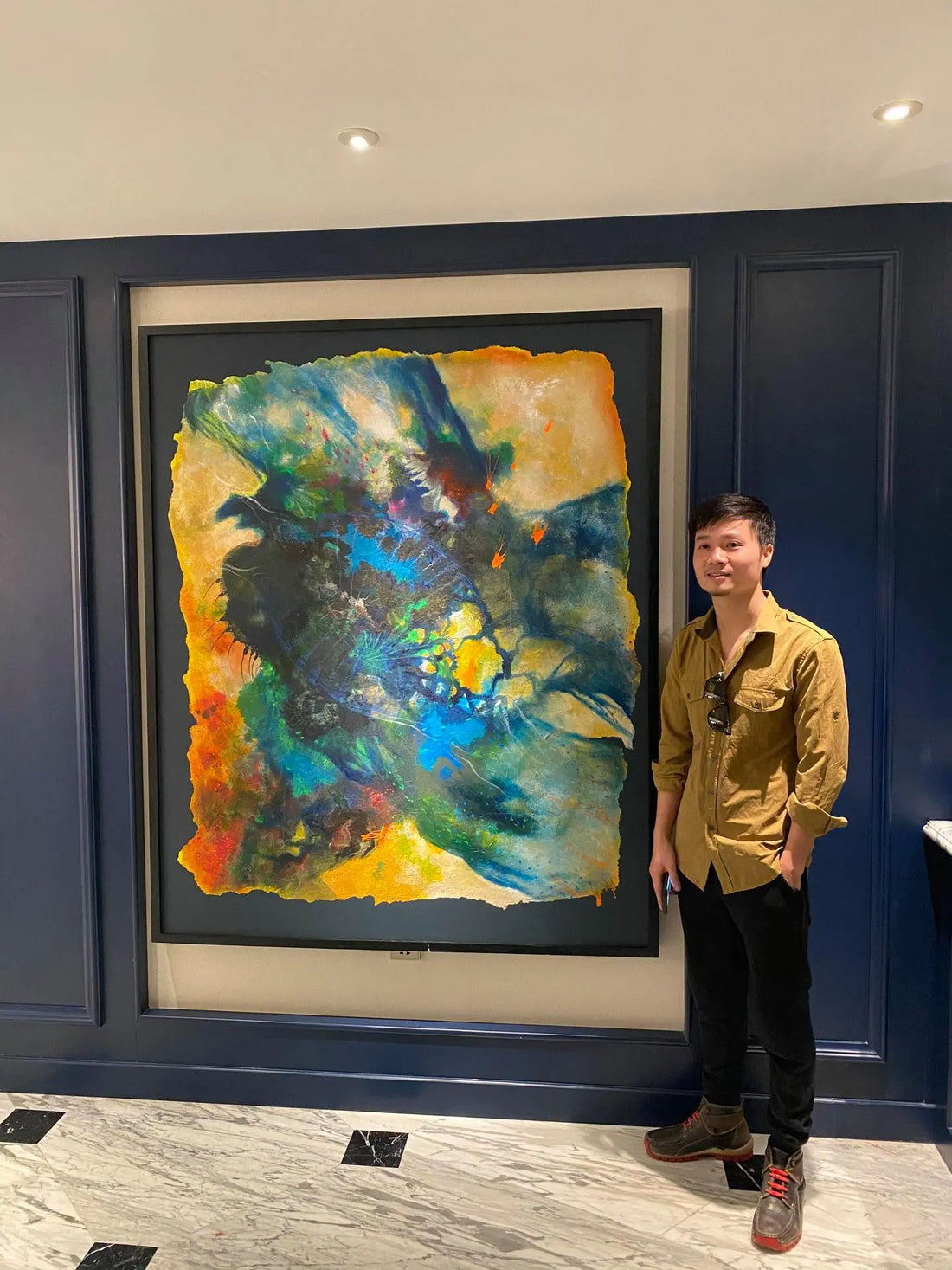 Nguyễn Văn Trinh with Vùng Sống artwork at exhibition