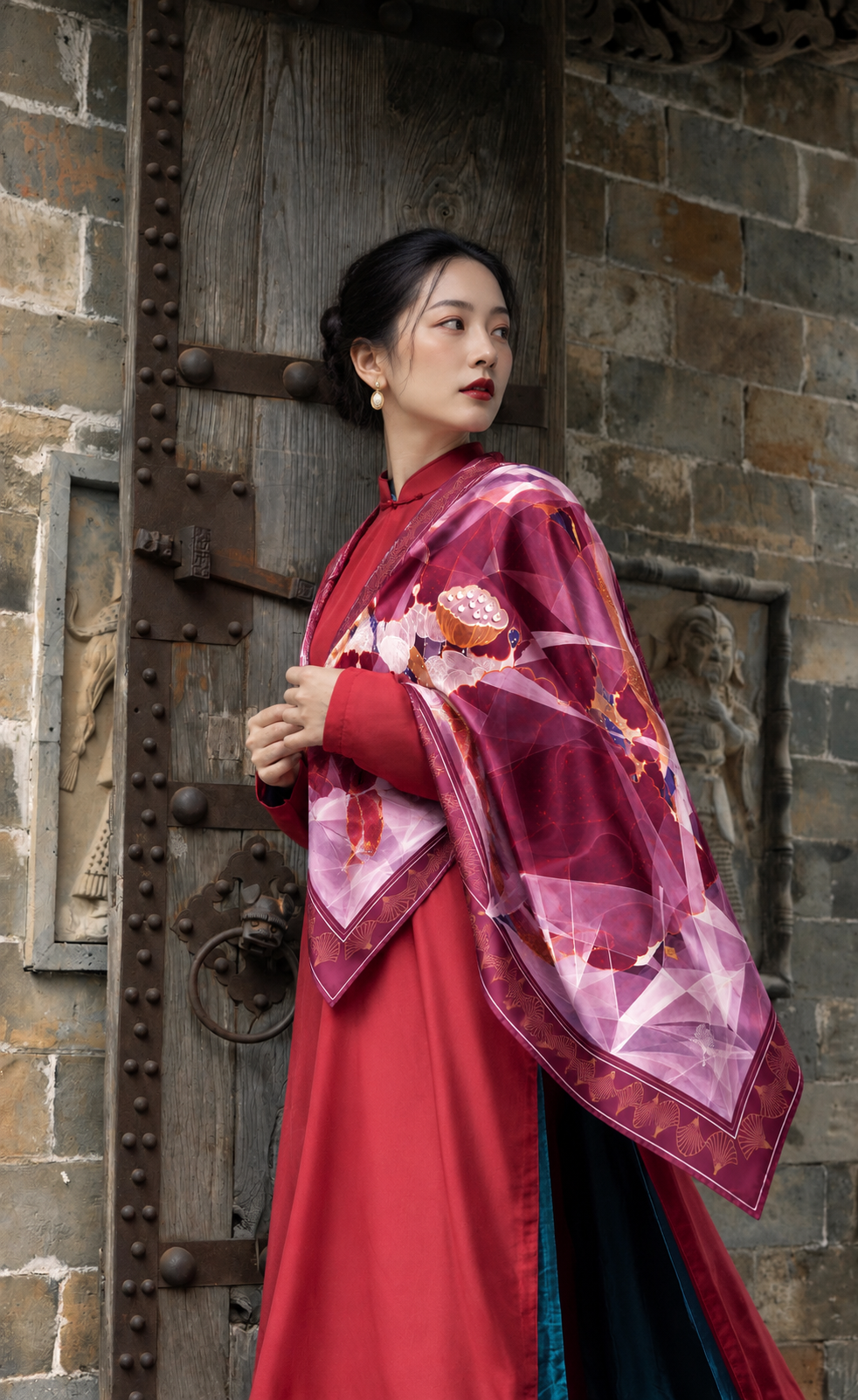 Red Lotus silk scarf by Nguyen Van Trinh against carved wooden architecture